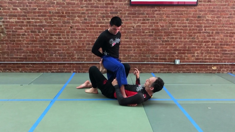 The bottom player wraps both legs around one of a standing opponent's legs in ashi-garami.