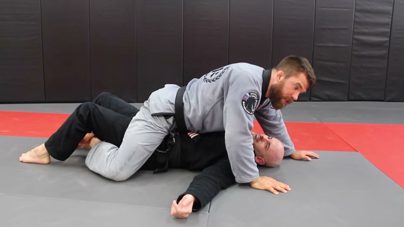 The top player sits on the bottom player's torso, facing the head, in mount.