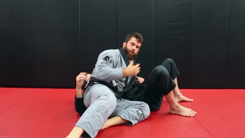 The top player pins from the side, chest across the bottom player's torso, in side control.